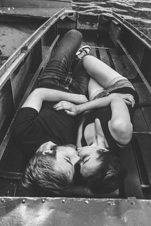 happy loving couple lying in the boatの写真素材