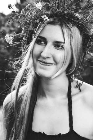 young beautiful girl in summer forest smiling