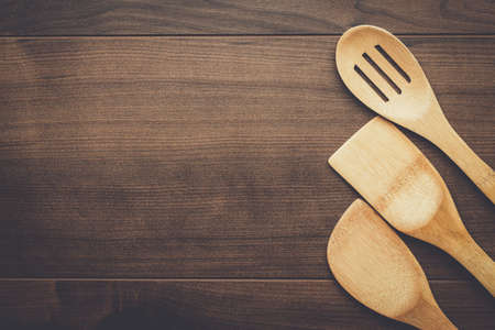 different wooden kitchen tools on the table with copy spaceの写真素材