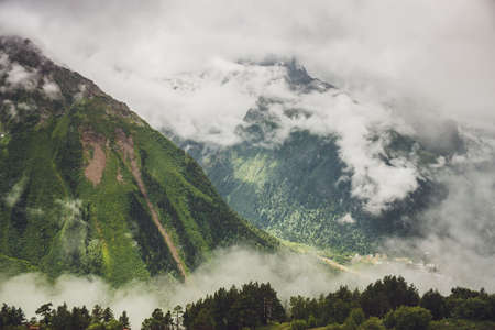 mountains with green grass and stormy sky landscapeの写真素材