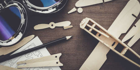 handmade airplane on the brown wooden tableの写真素材