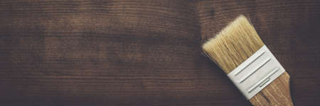 new paint brush on the brown wooden table backgroundの写真素材