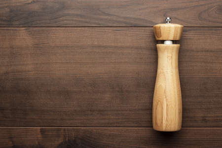 wooden salt shaker on the brown tableの写真素材