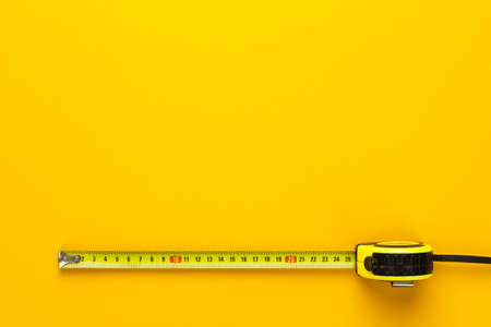 tape measure on the yellow background with copy space