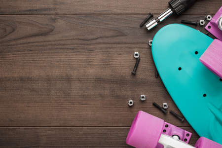 plastic mini cruiser board disassembled on wooden table with copy spaceの写真素材