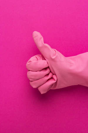 hand in pink protective glove shows thumbs up. cleaning service conceptの写真素材