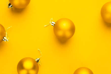 Christmas tree decoration balls on yellow backgroundの写真素材