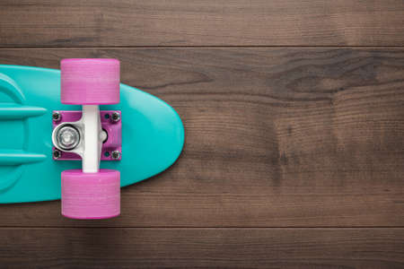plastic mini cruiser board on wooden background with copy spaceの写真素材