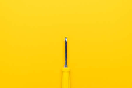close-up of manual screwdriver with plastic handle on the yellow backgroundの写真素材
