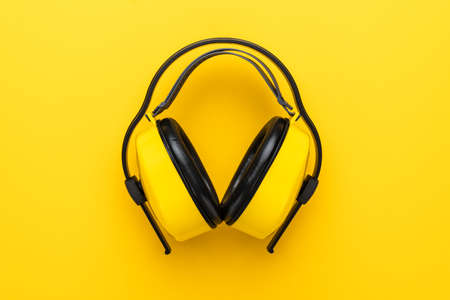 hearing protection industrial ear muffs on yellow backgroundの写真素材