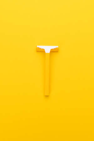 disposable unisex razor on the yellow backgroundの写真素材
