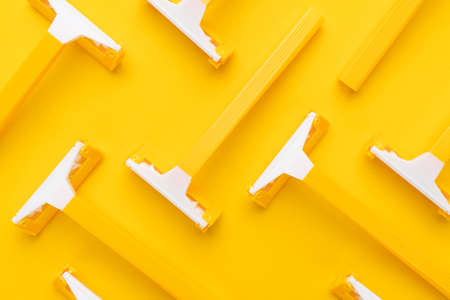 many unisex razors on the yellow backgroundの写真素材