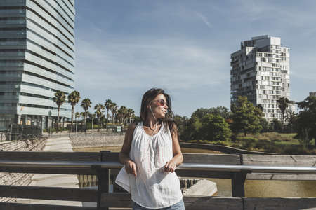 portrait of young woman listening to the music on the phoneの写真素材
