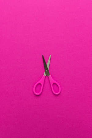 opened childrens scissors on the magenta background. vertical orientationの写真素材