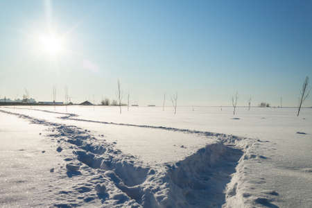 shot of snowy landscape with two footpathesの写真素材