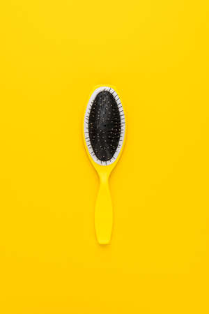 scalp massage comb on the yellow backgroundの写真素材