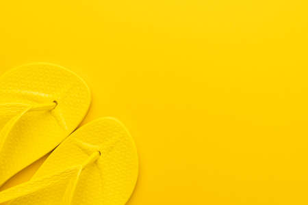 beach flip-flops on the yellow background with copy space. summer conceptの写真素材