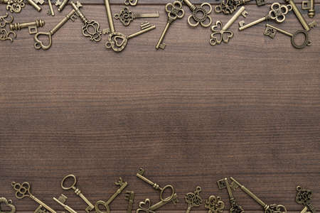 many different vintage keys concept on wooden background with copy spaceの写真素材