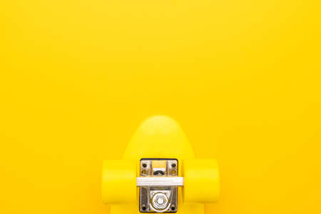 plastic mini cruiser board on yellow background. bright yellow cruiser skateboard with copy spaceの写真素材