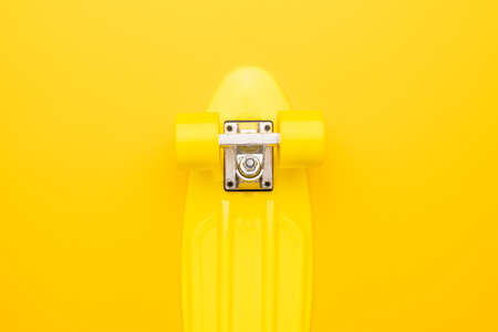 bright yellow mini cruiser board on yellow backgroundの写真素材
