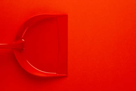 top view of plastic dustpan on red background with copy space