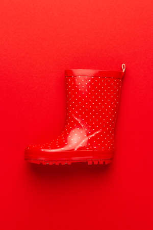 new childrens stylish gumboot on red backgroundの写真素材