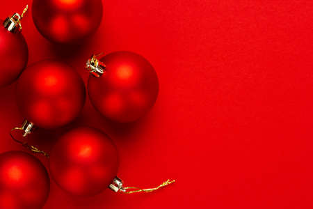 Christmas tree decoration balls on red background with copy spaceの写真素材