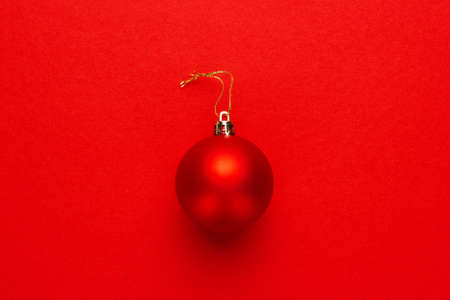 Christmas tree decoration ball on red backgroundの写真素材