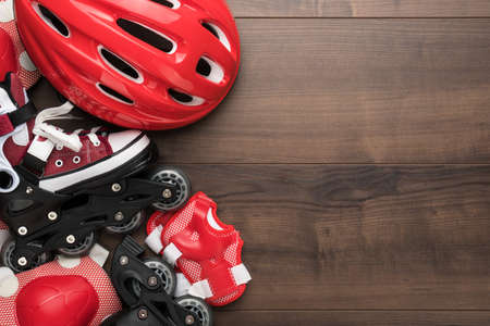 Roller skates and body parts protection on brown table with copy spaceの写真素材