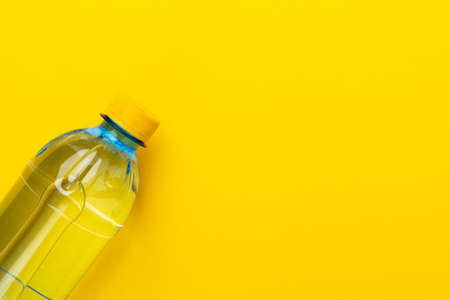 Plastic water bottle with yellow cap on the yellowの写真素材