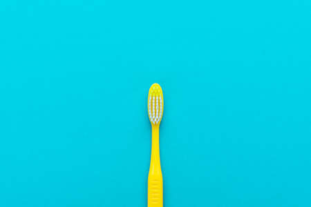 Top view of plastic toothbrush on the blue
