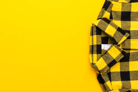 Yellow and black checkered shirt on the yellowの写真素材