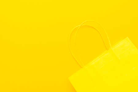 Shopping paper bag on the yellow  with copy space.の写真素材