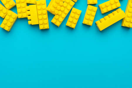 Top view of yellow plastic blocks. Flat lay image of yellow blocks from child constructor.の写真素材