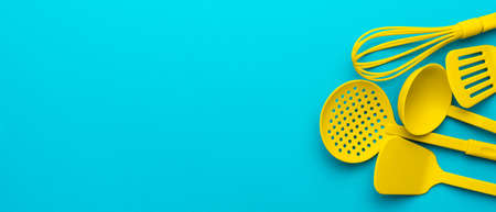 Top view photo of vivid plastic kitchen utensils.
