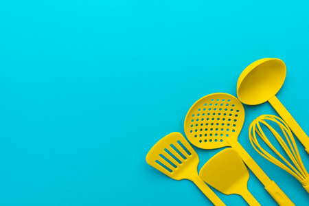 Top view photo of vivid plastic kitchen utensils.
