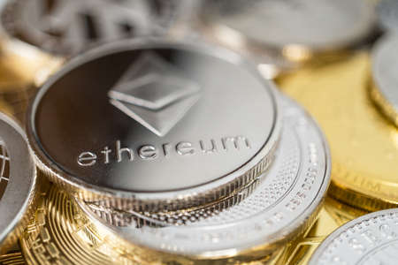 Ether physical coin on the stack of other different cryptocurrencies. Close-up photo of ether with shallow depth of fieldの写真素材