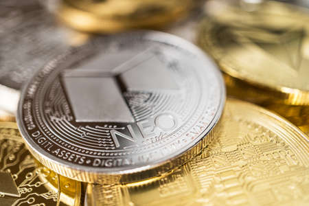 Neo physical coin on the stack of other different cryptocurrencies