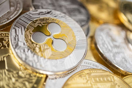 Ripple physical coin on the stack of other different cryptocurrencies.の写真素材