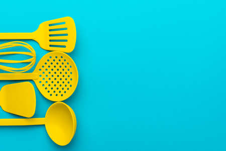Top view photo of vivid plastic kitchen utensils.