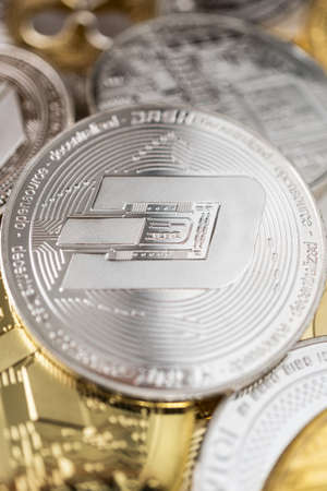 Dash physical coin on the stack of other different cryptocurrencies.の写真素材