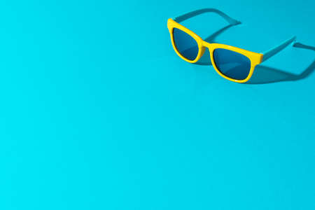 Yellow sunglasses with harsh shadow as summer concept.の写真素材