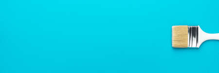Minimalist banner style photo of white brush central composition. Paint brush on the turquoise blue background.の写真素材