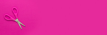 Children scissors on the magenta background with copy spaceの写真素材