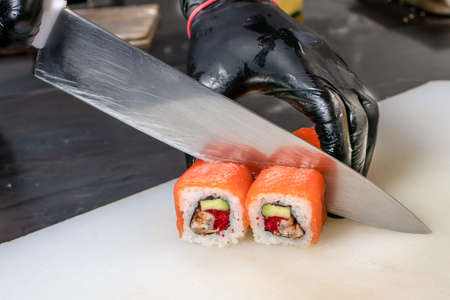 Cut the sushi into pieces. Rolls, cooking. Japanese cuisineの写真素材