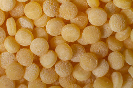 Macro photo couscous. Yellow grains of wheat grits, cuscus, semolina, universal porridge for breakfast.の写真素材