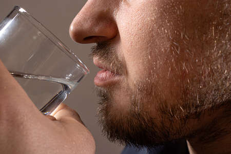 A man and a glass of vodka. Alcoholism, alcohol addiction, delirium tremens.の写真素材