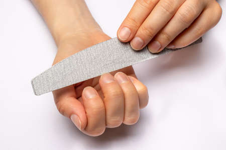 Manicure at home, sawing nails with a sawn-off and giving a square shape to the nail plate. Caring for nails.の写真素材