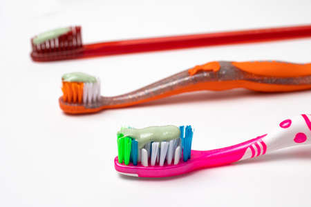 Three toothbrushes for the whole family. Care for the mouth, brushing teeth. Toothpaste and toothbrush.の写真素材
