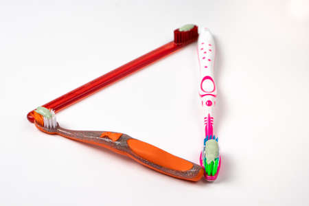 Three toothbrushes for the whole family. Care for the mouth, brushing teeth. Toothpaste and toothbrush.の写真素材